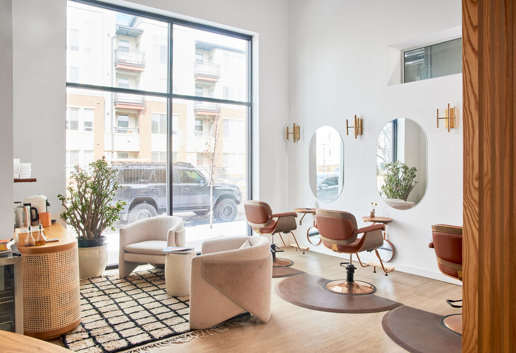 Light-filled salon interior with styling chairs and mirrors