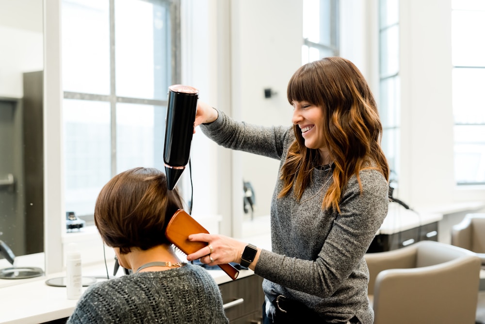 Stylist working with a client in an elevated salon setting