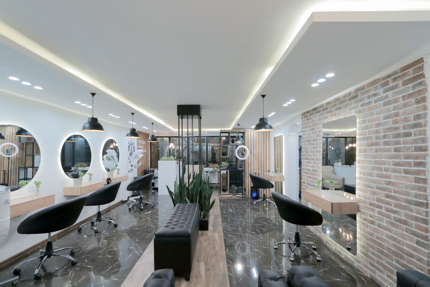 Stylist finishing a client appointment in a salon chair